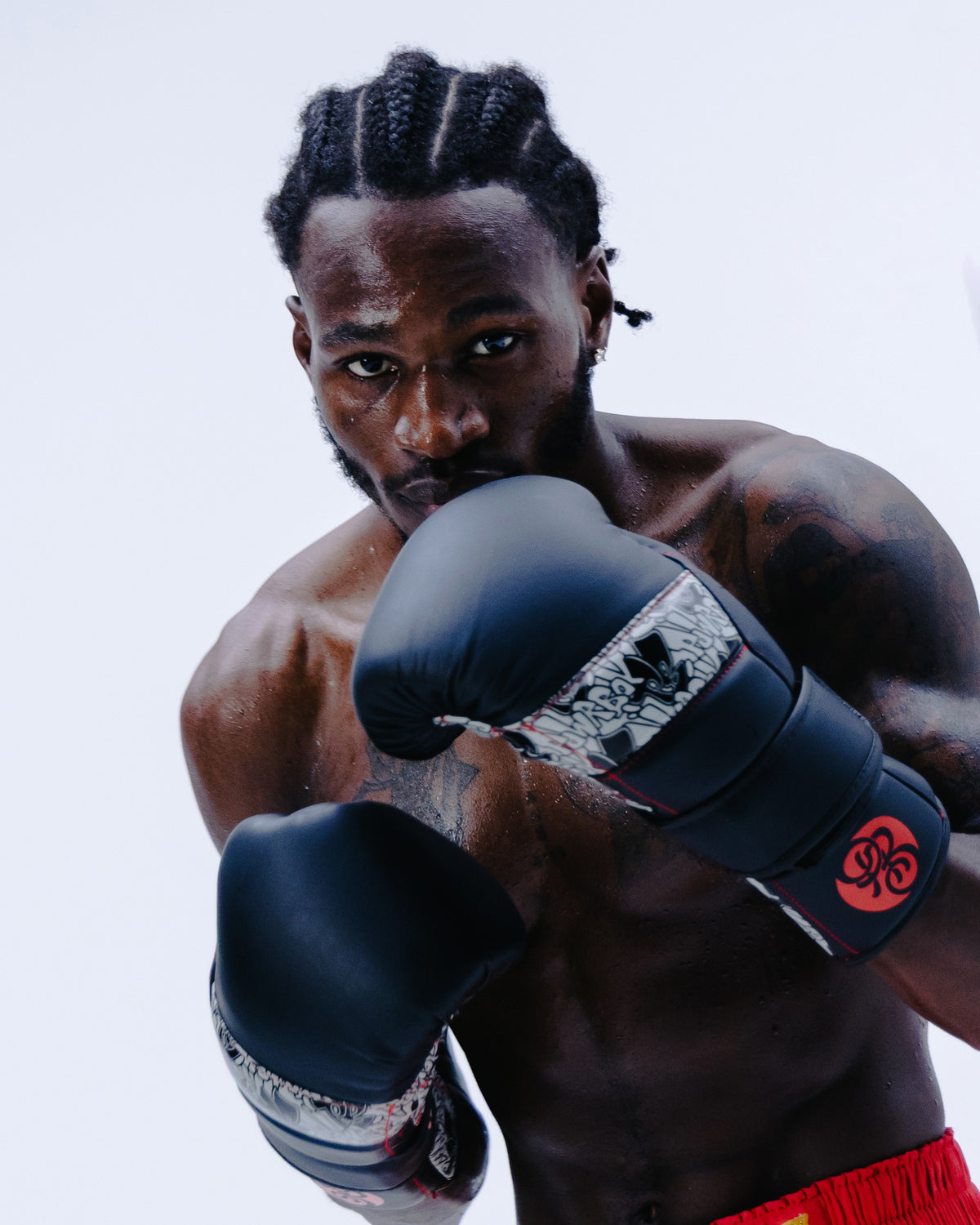 Boxer in guard wearing Powrbox D-Strap Double Velcro Gloves in Bloodline matte black, grey and red
