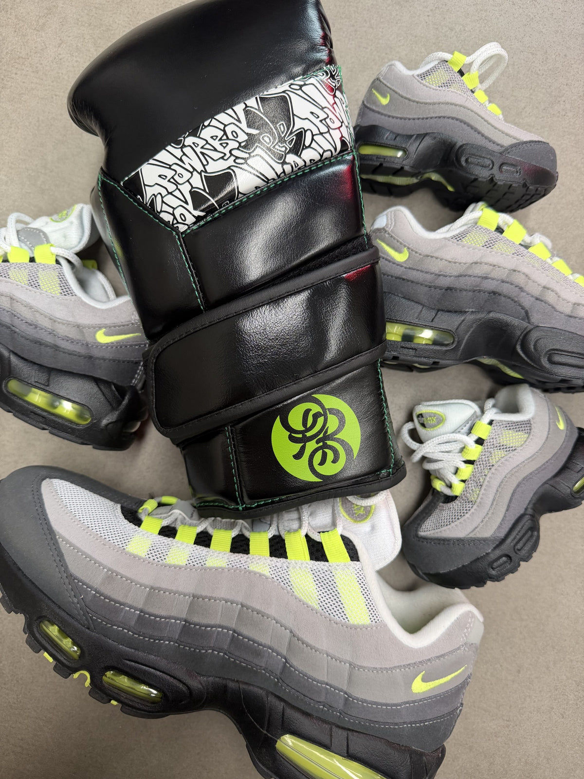 Powrbox boxing glove surrounded by Nike Air Max 95 sneakers