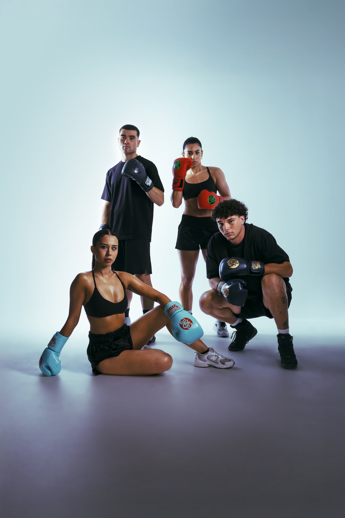 Four boxers posing in Powrbox boxing gloves and training gear