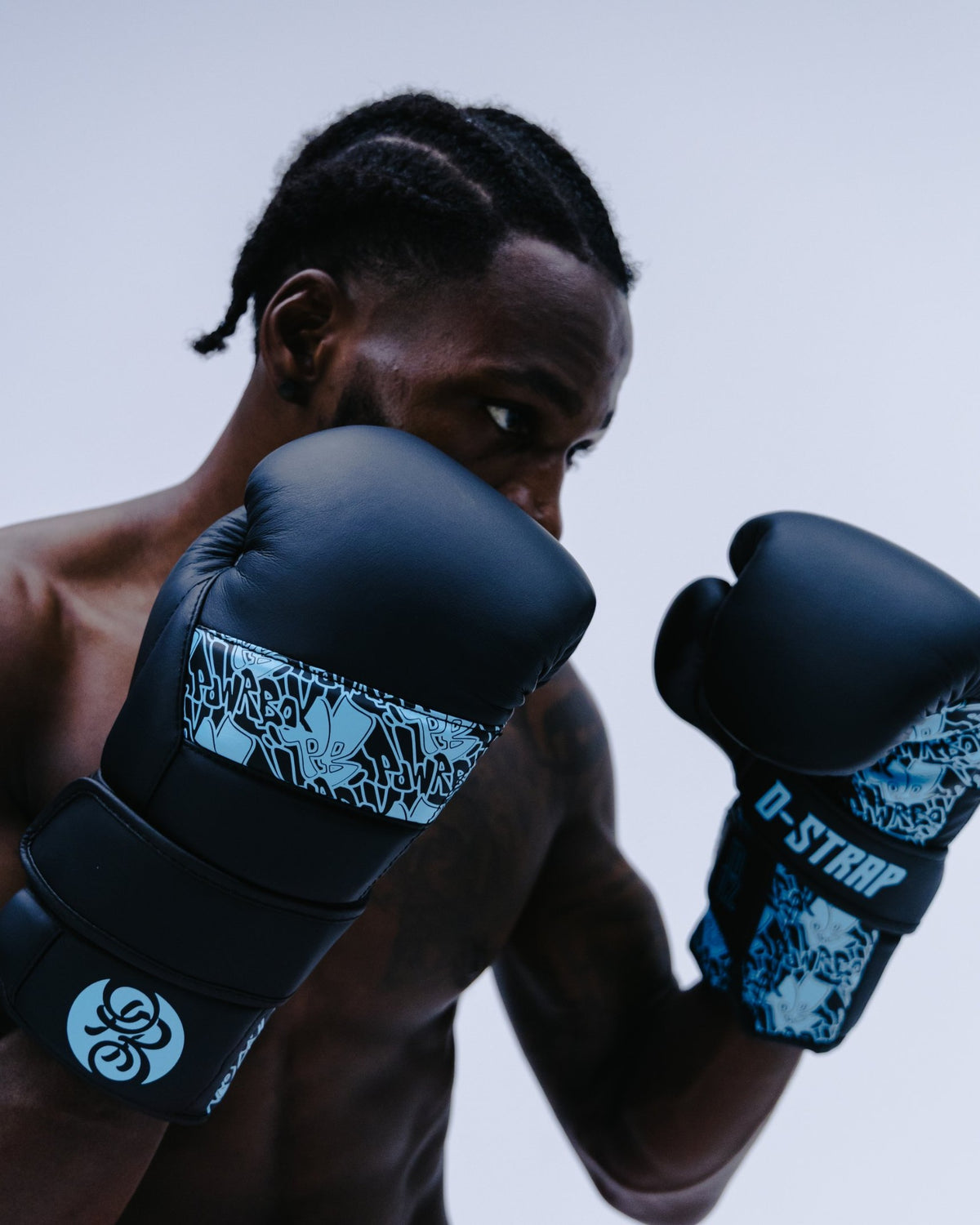 Boxer in guard wearing Powrbox D-Strap Double Velcro Gloves in Surge matte black and light blue
