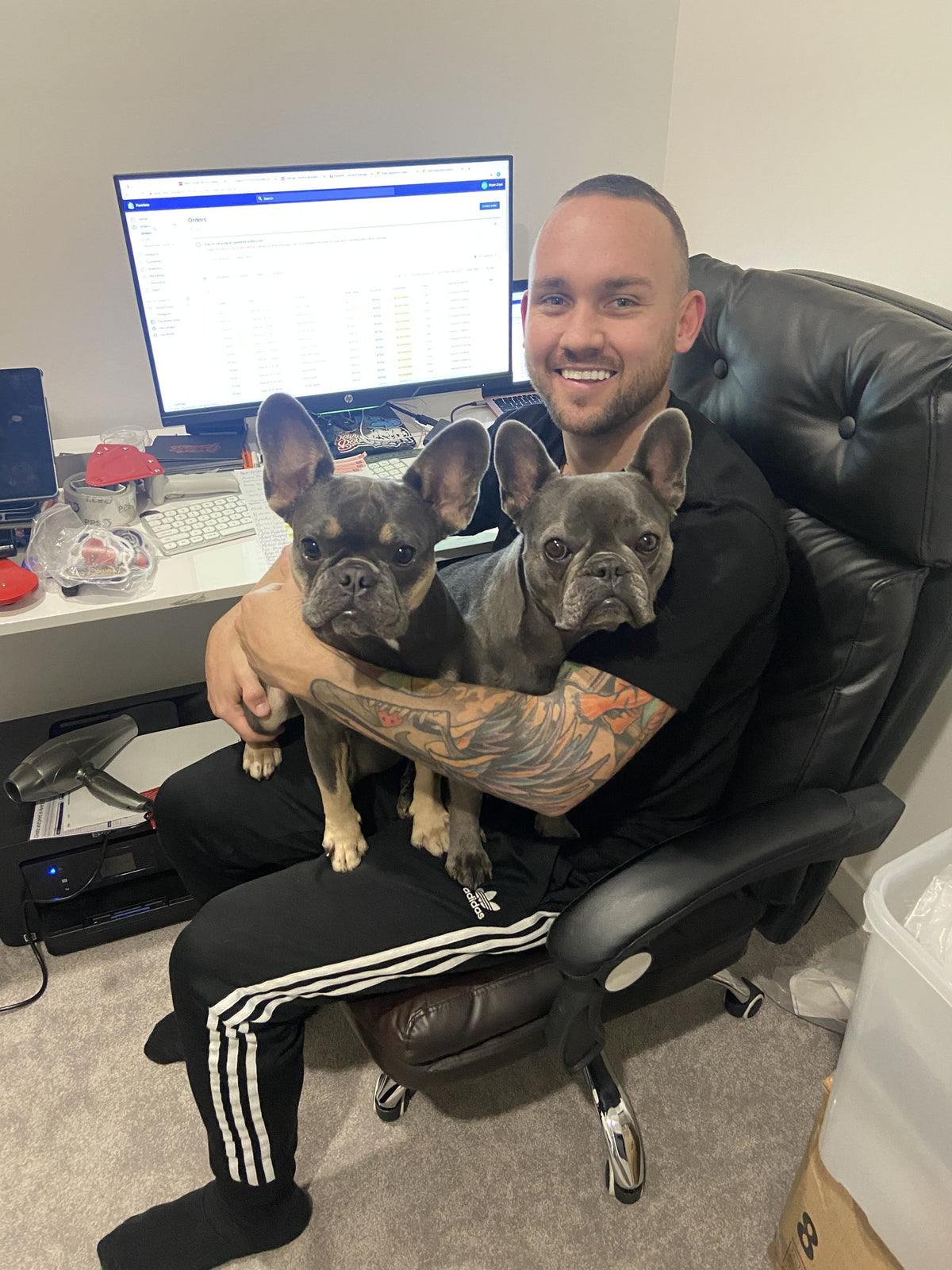 Bryce packing Powrbox orders in his apartment bedroom office with his dogs King and Koko